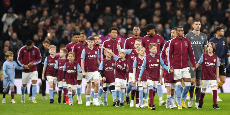 Aston Villa players walk on to the pitch